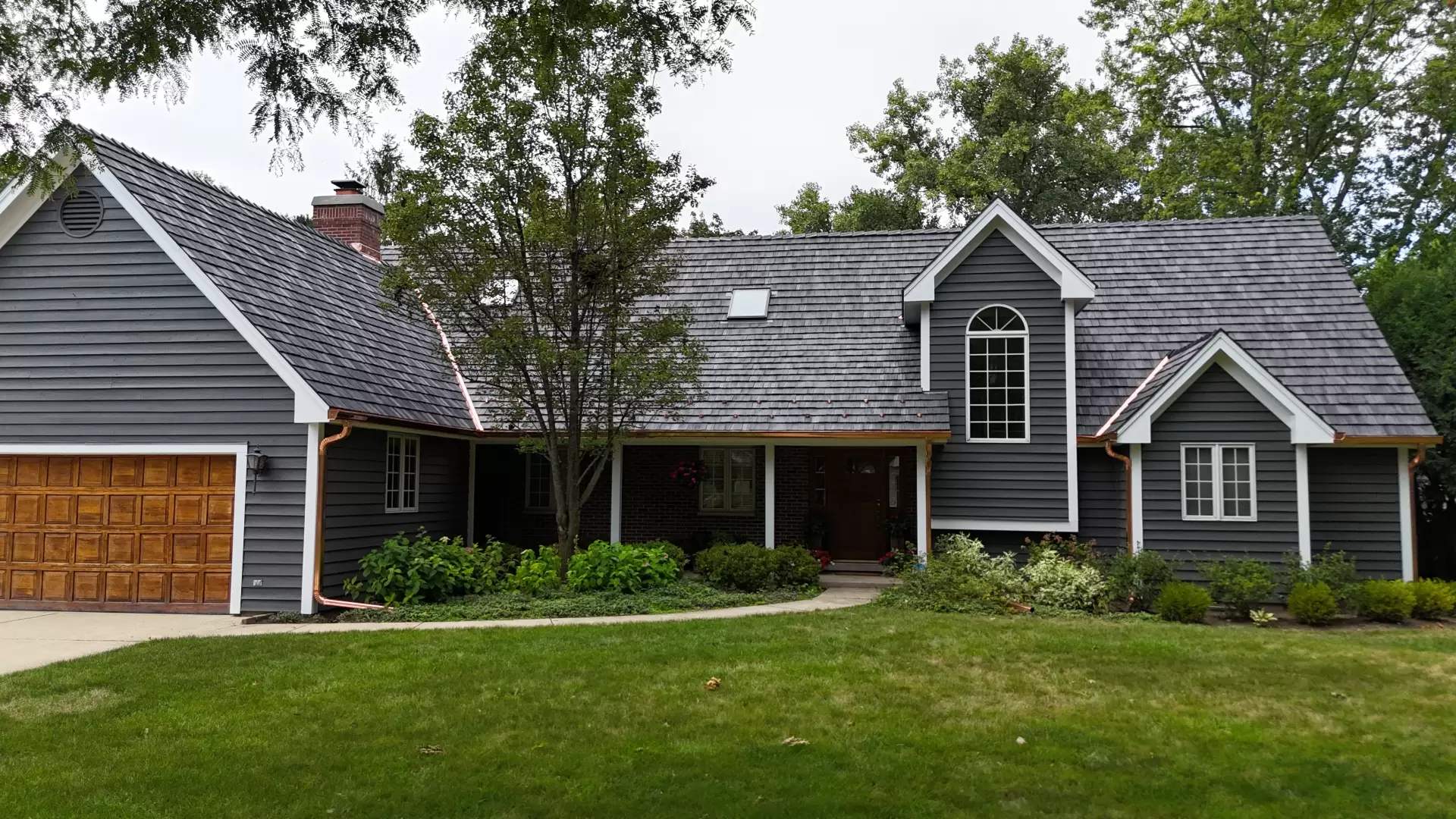 Large skylight next to window on grey roof