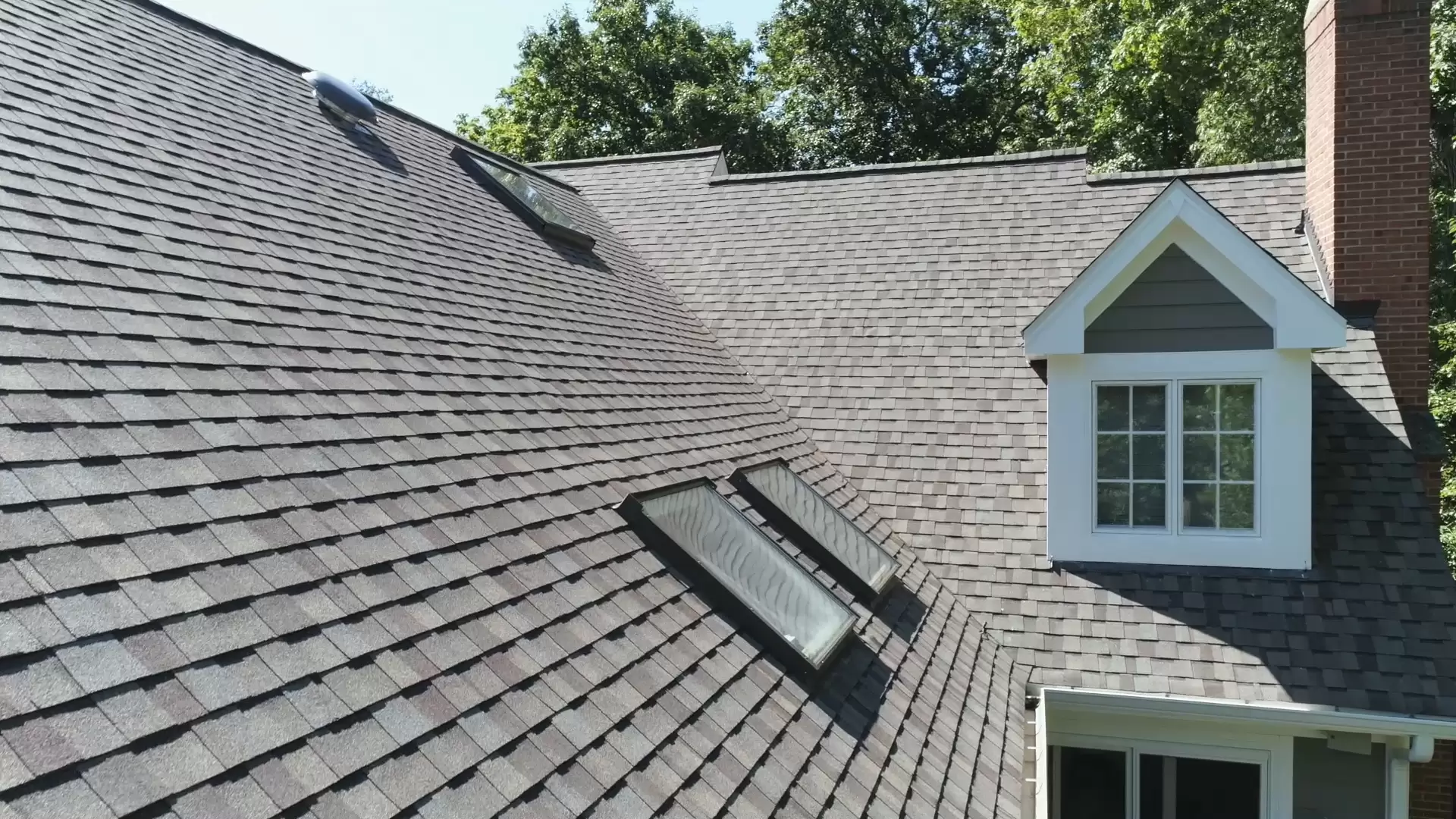 Two skylights on grey roof from side