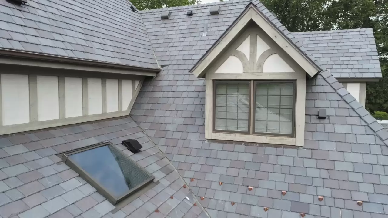 Large skylight next to window on grey roof