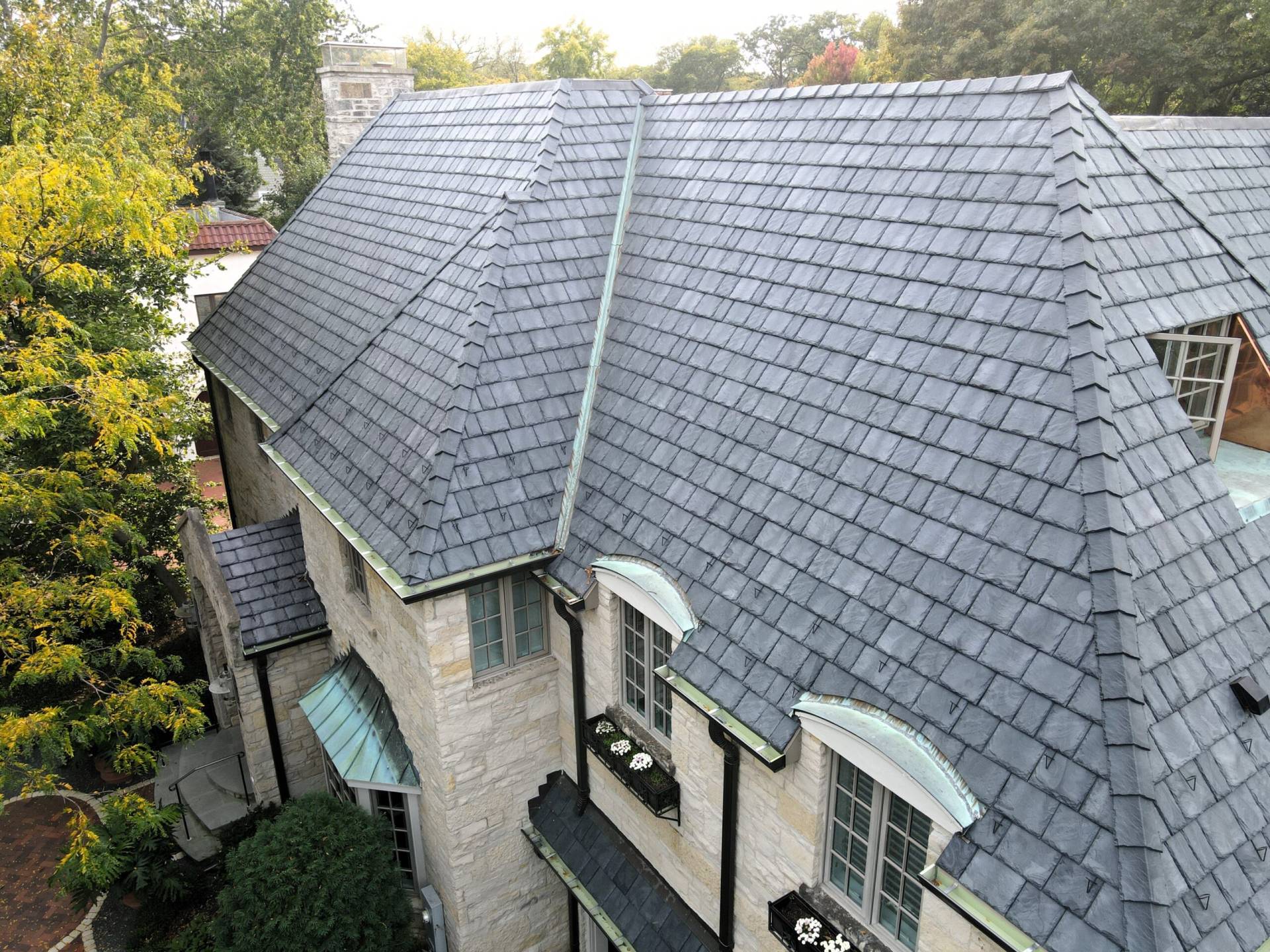 Large skylight next to window on grey roof