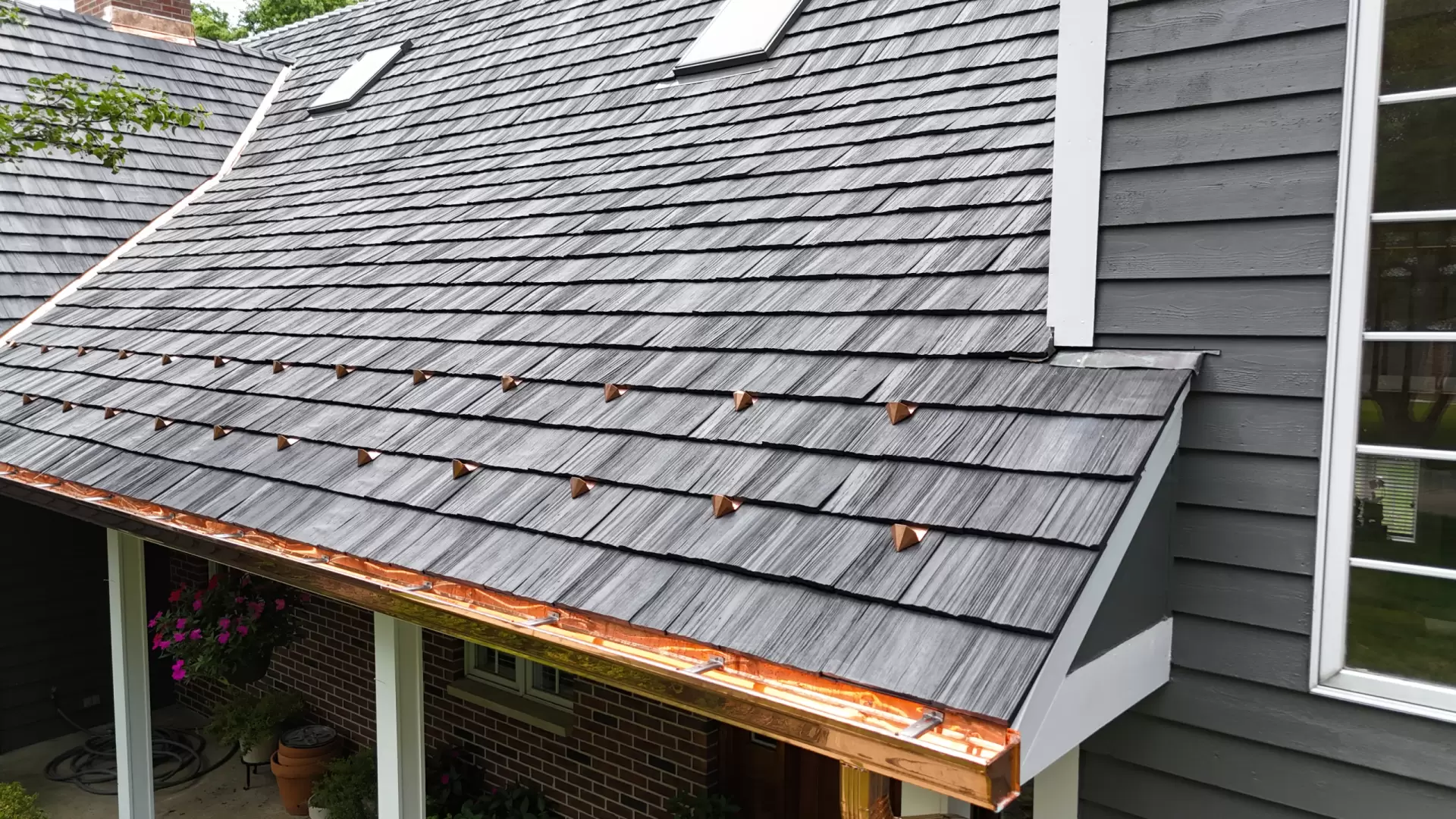 Large skylight next to window on grey roof