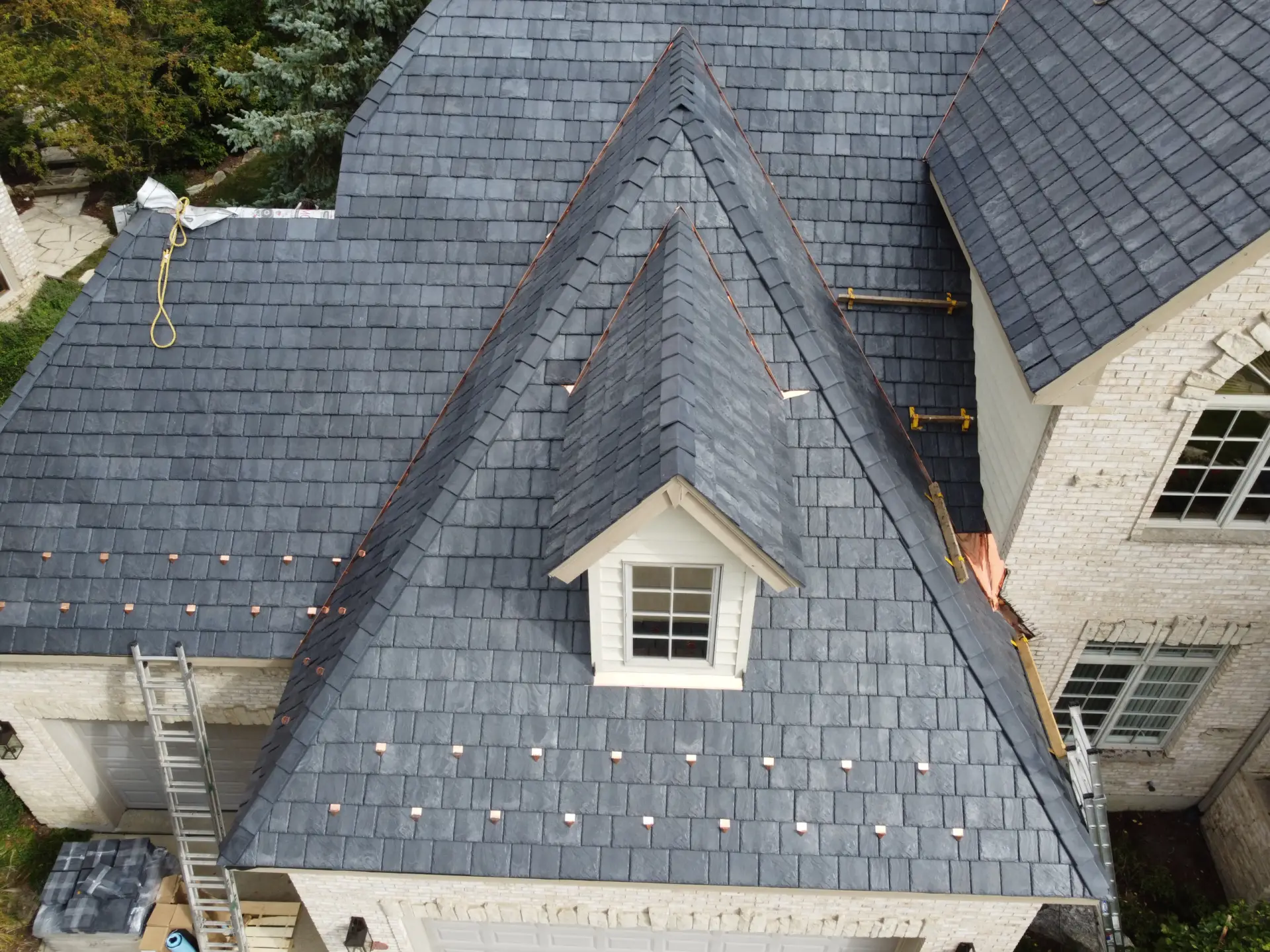 Large skylight next to window on grey roof