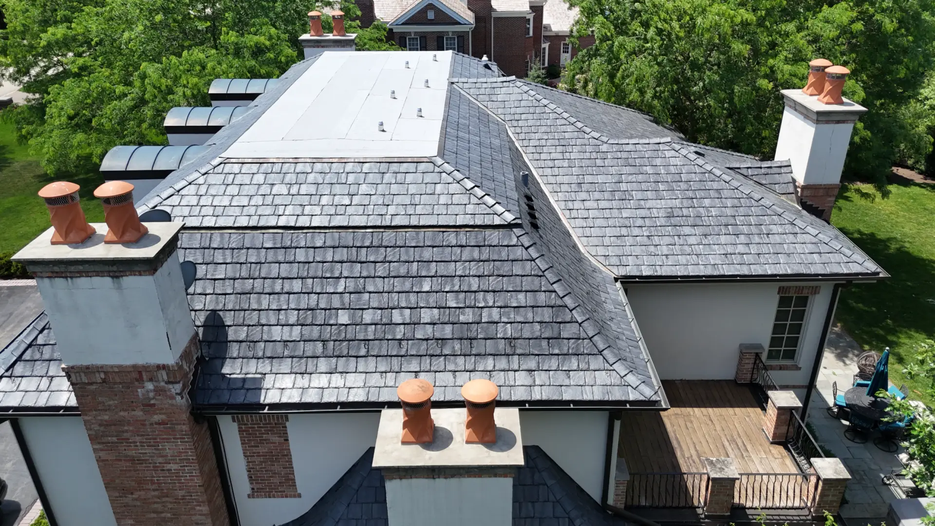 Large skylight next to window on grey roof