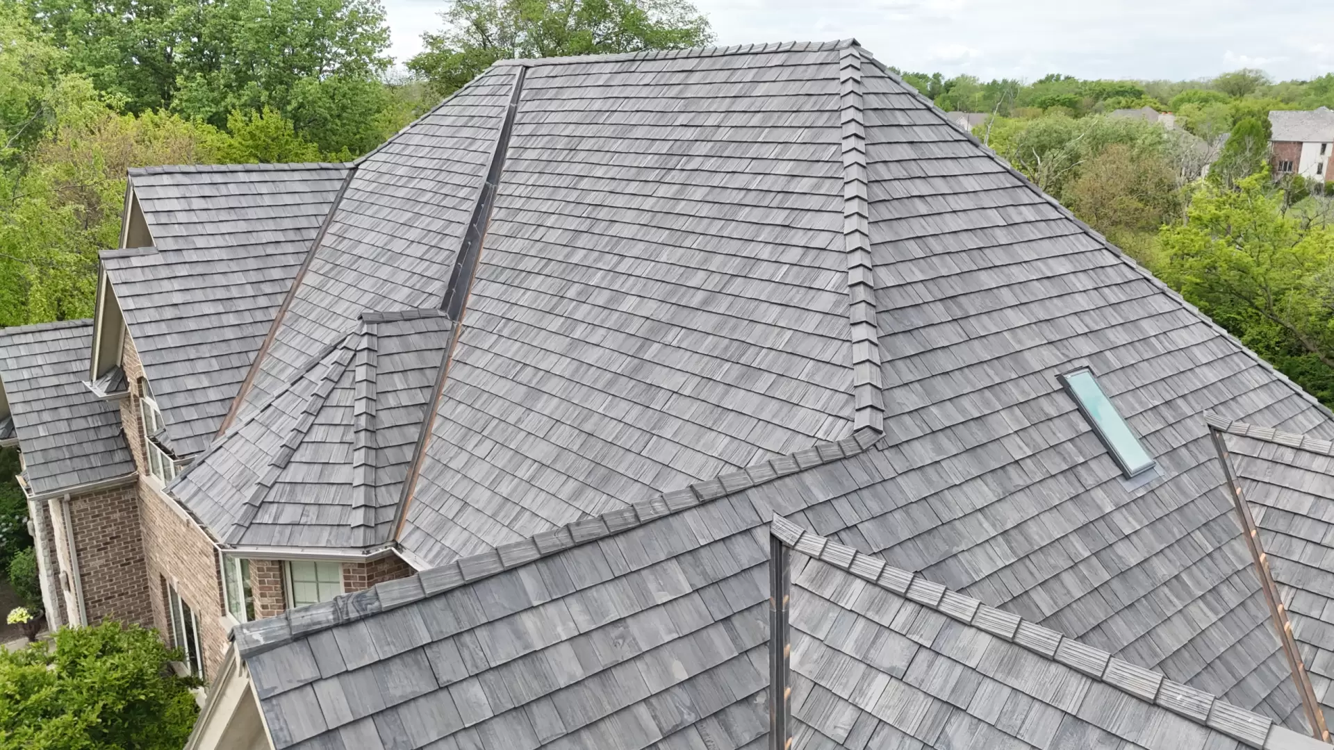 Large skylight next to window on grey roof