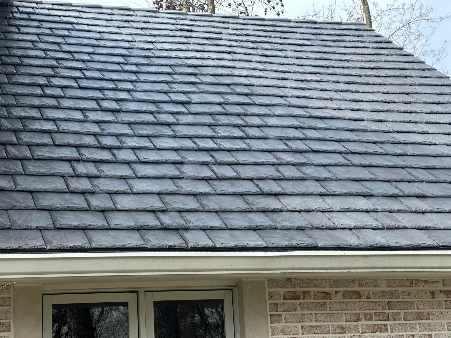 Large skylight next to window on grey roof