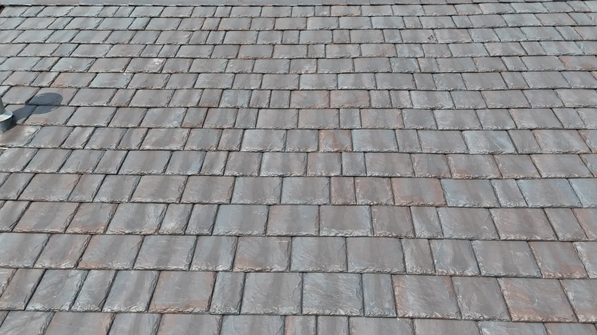 Large skylight next to window on grey roof